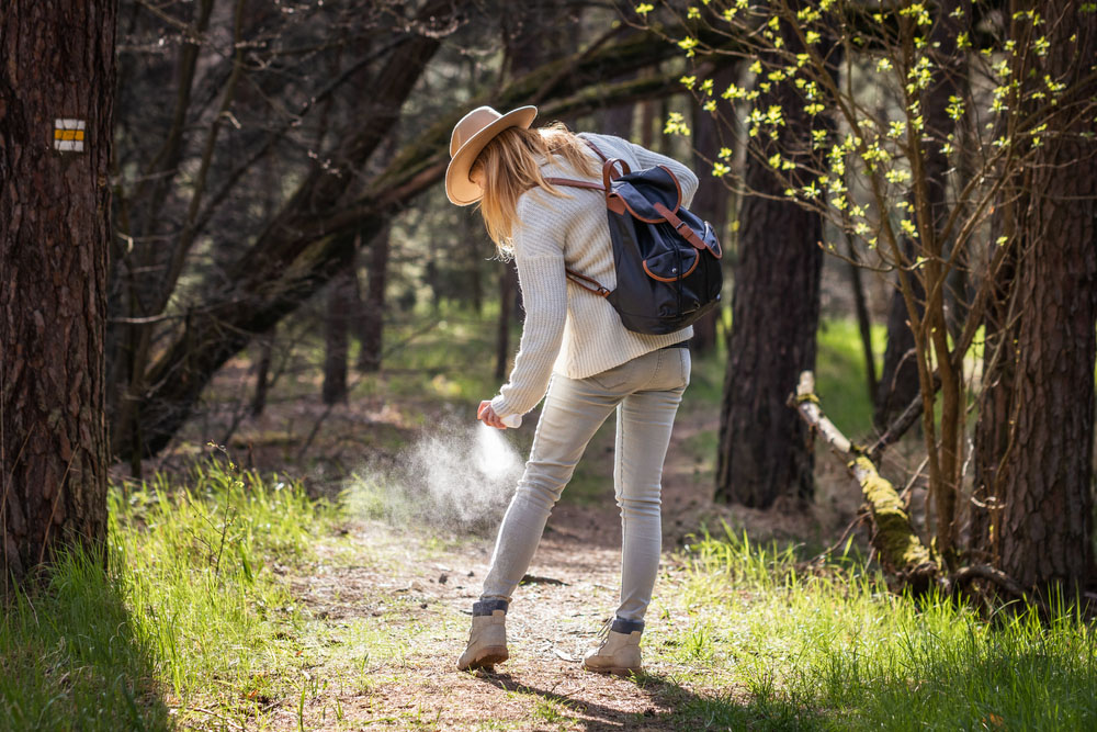 Woman,Spraying,Insect,Repellent,Against,Tick,At,Her,Legs.,Protection